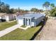 Aerial view of a new gray house with white garage door and a paved driveway at 3515 55Th Ave N, St Petersburg, FL 33714
