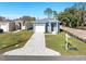 Aerial view of a new gray house with a white garage and paved driveway at 3515 55Th Ave N, St Petersburg, FL 33714