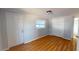 Cozy bedroom with wood-look flooring, a window, and a closet at 3515 55Th Ave N, St Petersburg, FL 33714