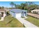 New house with gray siding, white garage door, and a stone driveway at 3515 55Th Ave N, St Petersburg, FL 33714