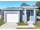 Newly constructed home with gray exterior, white garage door, and a paved driveway at 3515 55Th Ave N, St Petersburg, FL 33714