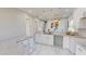 Modern kitchen with white cabinets, granite countertops, and stainless steel appliances at 3515 55Th Ave N, St Petersburg, FL 33714