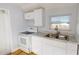 Efficient kitchen with white cabinets, granite counters, and modern appliances at 3515 55Th Ave N, St Petersburg, FL 33714