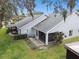 Backyard view showing screened patio and lush landscaping at 3624 Muirfield Ct, New Port Richey, FL 34655