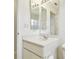 Bathroom features a vanity with sink and mirror, providing ample counter space at 3624 Muirfield Ct, New Port Richey, FL 34655