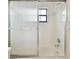 Clean bathroom with a shower/tub combo and frosted glass door at 3624 Muirfield Ct, New Port Richey, FL 34655