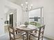 Bright dining room with round table and chairs, view to kitchen at 3624 Muirfield Ct, New Port Richey, FL 34655