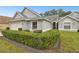 Gray house with two-car garage and lush green hedges at 3624 Muirfield Ct, New Port Richey, FL 34655