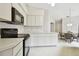 Clean kitchen with white cabinets and black appliances at 3624 Muirfield Ct, New Port Richey, FL 34655