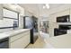 White kitchen with black appliances and ample counter space at 3624 Muirfield Ct, New Port Richey, FL 34655