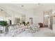 Bright living room with floral sofas and large mirror reflecting the space at 3624 Muirfield Ct, New Port Richey, FL 34655