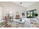 Living room with glass coffee table and floral sofas at 3624 Muirfield Ct, New Port Richey, FL 34655