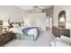 Main bedroom with large bed, double vanities, and ample closet space at 3624 Muirfield Ct, New Port Richey, FL 34655