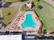 Aerial view of resort-style pool with surrounding lounge chairs at 3624 Muirfield Ct, New Port Richey, FL 34655
