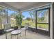 Relaxing screened porch with patio furniture and view of the backyard at 3624 Muirfield Ct, New Port Richey, FL 34655