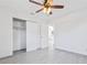 Bright bedroom featuring modern ceiling fan, light gray flooring, a closet, and an open door at 364 3Rd Nw St, Largo, FL 33770