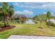 Landscaped backyard with pond and grassy areas at 3715 Front Park Dr, Wesley Chapel, FL 33543