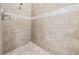 Shower with beige tile and stone accent at 3803 Bonfire Dr, Odessa, FL 33556