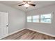 Bedroom with grey walls, wood-look floors, and a ceiling fan at 4001 58Th N St # 26C, St Petersburg, FL 33709