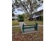 Green bench along a paved pathway in a community at 4001 58Th N St # 26C, St Petersburg, FL 33709