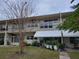 Two-story condominium building with balconies and landscaping at 4001 58Th N St # 26C, St Petersburg, FL 33709