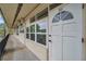 Building exterior showcasing a walkway, white door, and multiple windows at 4001 58Th N St # 26C, St Petersburg, FL 33709