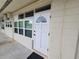 Exterior view of condo building showcasing a white door and windows at 4001 58Th N St # 26C, St Petersburg, FL 33709