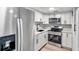 Modern kitchen featuring white cabinets, stainless steel appliances, and quartz countertops at 4001 58Th N St # 26C, St Petersburg, FL 33709