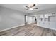 Open living room with wood-look floors and a view into the kitchen at 4001 58Th N St # 26C, St Petersburg, FL 33709