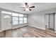 Living room with light grey walls, wood-look flooring, and ceiling fan at 4001 58Th N St # 26C, St Petersburg, FL 33709
