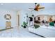 Open living room with white sectional sofa, a view into the kitchen, and marble floors at 4147 Huntington Ne St, St Petersburg, FL 33703