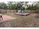 Large backyard with a wooden deck, shed, and fenced area at 438 E Martin Luther King Jr Dr, Tarpon Springs, FL 34688