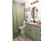 Clean bathroom with green vanity, shower, and toilet at 438 E Martin Luther King Jr Dr, Tarpon Springs, FL 34688