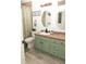 Updated bathroom with green vanity, new flooring and fixtures at 438 E Martin Luther King Jr Dr, Tarpon Springs, FL 34688