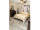 Bright bedroom with a queen bed, dresser, and wood-look flooring at 438 E Martin Luther King Jr Dr, Tarpon Springs, FL 34688