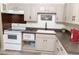 Bright kitchen features white appliances and light taupe cabinets at 438 E Martin Luther King Jr Dr, Tarpon Springs, FL 34688