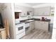 Kitchen with light cabinets, updated flooring and appliances at 438 E Martin Luther King Jr Dr, Tarpon Springs, FL 34688
