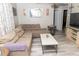 Spacious living room with L-shaped sofa and wood-look floors at 438 E Martin Luther King Jr Dr, Tarpon Springs, FL 34688