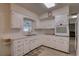 Bright kitchen featuring white cabinets and modern appliances at 4401 37Th N Ave, St Petersburg, FL 33713