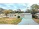 Ranch home with a long driveway, surrounded by trees at 4502 S Shamrock Rd, Tampa, FL 33611