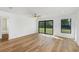 Bright bedroom with hardwood floors and sliding glass doors to backyard at 4621 Kenoska St, North Port, FL 34288