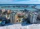 Aerial view of luxury beachfront condos, pool, and city skyline at 470 Mandalay Ave # 305, Clearwater Beach, FL 33767