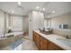 Elegant bathroom with double vanity, soaking tub, and separate shower at 470 Mandalay Ave # 305, Clearwater Beach, FL 33767