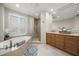 Spa-like bathroom with soaking tub, walk-in shower, and double vanity at 470 Mandalay Ave # 305, Clearwater Beach, FL 33767
