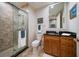 Updated bathroom with walk-in shower, toilet and granite vanity at 470 Mandalay Ave # 305, Clearwater Beach, FL 33767