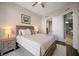 Bright bedroom with a queen bed, nightstands, and access to bathroom at 470 Mandalay Ave # 305, Clearwater Beach, FL 33767