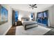 Main bedroom with king-size bed, hardwood floors, and access to a private balcony at 470 Mandalay Ave # 305, Clearwater Beach, FL 33767