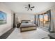 Spacious bedroom with king bed, hardwood floors, and a ceiling fan at 470 Mandalay Ave # 305, Clearwater Beach, FL 33767