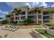 Building exterior with landscaping and lounge chairs at 470 Mandalay Ave # 305, Clearwater Beach, FL 33767