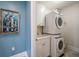 Convenient laundry room with washer, dryer, and cabinets at 470 Mandalay Ave # 305, Clearwater Beach, FL 33767